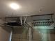Garage with overhead storage racks and bright lighting installed for organization at 713 Parkside Dr, Woodstock, GA 30188