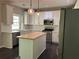Stylish kitchen with white cabinets, stainless steel appliances, and a butcher block island at 713 Parkside Dr, Woodstock, GA 30188