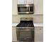 Updated kitchen featuring stainless steel appliances, modern countertop, and subway tile backsplash at 713 Parkside Dr, Woodstock, GA 30188