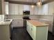 Modern kitchen featuring white cabinets, stainless steel appliances, and a butcher block island at 713 Parkside Dr, Woodstock, GA 30188