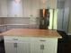 Bright kitchen featuring an island, white cabinetry, stainless steel refrigerator, and modern lighting at 713 Parkside Dr, Woodstock, GA 30188