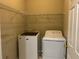 Laundry room featuring a washing machine, dryer, and wire shelving for ample storage space at 713 Parkside Dr, Woodstock, GA 30188
