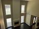 Bright living room featuring a fireplace, tall ceilings, dark floors, and a fan at 713 Parkside Dr, Woodstock, GA 30188