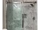 Modern shower featuring marble-style tile, a rainfall shower head, and a glass sliding door at 713 Parkside Dr, Woodstock, GA 30188