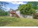 Expansive backyard featuring a well-maintained lawn, mature trees, and a home exterior with a spacious deck at 2591 Boulder Hill Se Ct, Atlanta, GA 30316