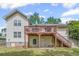 Exterior view of home's backyard with wood deck and stairs, showcasing outdoor living space and mature landscaping at 2591 Boulder Hill Se Ct, Atlanta, GA 30316