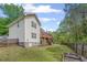 Large backyard with well-manicured lawn, wooden fence, and a view of the home's exterior with a deck at 2591 Boulder Hill Se Ct, Atlanta, GA 30316