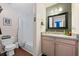 Well-lit bathroom with a granite vanity, a spacious shower and tub combo, and wood look floors at 2591 Boulder Hill Se Ct, Atlanta, GA 30316