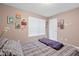 Comfortable bedroom features a double window, bright natural light, colorful art, and carpeted floors at 2591 Boulder Hill Se Ct, Atlanta, GA 30316