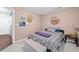 Cozy bedroom with neutral carpet, colorful wall art, and a comfortable bed with a bench at 2591 Boulder Hill Se Ct, Atlanta, GA 30316