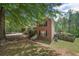 Exterior view of a brick home with a manicured lawn, mature trees, and a side-entry driveway at 2591 Boulder Hill Se Ct, Atlanta, GA 30316