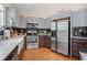 Well-equipped kitchen with stainless steel appliances, two-tone cabinets, and hardwood floors at 2591 Boulder Hill Se Ct, Atlanta, GA 30316
