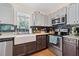 Bright kitchen featuring a farmhouse sink, stainless steel appliances, and dark backsplash at 2591 Boulder Hill Se Ct, Atlanta, GA 30316