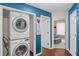 Convenient laundry room features a stacked washer and dryer, offering space-saving efficiency for everyday chores at 2591 Boulder Hill Se Ct, Atlanta, GA 30316
