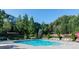 Community pool surrounded by lush greenery, offering a refreshing amenity for residents to enjoy swimming and relaxation at 2591 Boulder Hill Se Ct, Atlanta, GA 30316