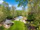 This aerial view showcases the gazebo, manicured lawn, and tennis court nestled among the lush green trees at 3 Woodlawn Ne Dr, Marietta, GA 30067