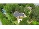 An aerial view of a brick home nestled in a lush green landscape, showcasing a well-maintained tennis court nearby at 3 Woodlawn Ne Dr, Marietta, GA 30067