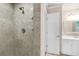 Updated bathroom with tiled shower, vanity, and a separate door leading to another room at 3 Woodlawn Ne Dr, Marietta, GA 30067