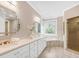 Bright bathroom with double sink vanity, soaking tub, and glass enclosed shower at 3 Woodlawn Ne Dr, Marietta, GA 30067