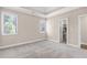 Bedroom with plush carpet, a walk-in closet, and bright, sun-filled windows at 3 Woodlawn Ne Dr, Marietta, GA 30067
