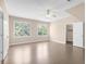 Spacious bedroom with hardwood floors, ceiling fan, two large windows, and closet at 3 Woodlawn Ne Dr, Marietta, GA 30067