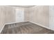 Neutral bedroom with carpeted floors, featuring a double door closet and a separate access door at 3 Woodlawn Ne Dr, Marietta, GA 30067