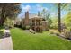 Back exterior view of home with balcony overlooking manicured lawn and gardens, showcasing a serene outdoor living at 3 Woodlawn Ne Dr, Marietta, GA 30067
