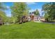 Beautiful brick home with lush lawn and fountain surrounded by mature trees at 3 Woodlawn Ne Dr, Marietta, GA 30067