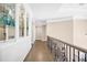 Hallway with hardwood floors, decorative railing, and tray ceilings at 3 Woodlawn Ne Dr, Marietta, GA 30067