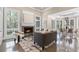 Cozy living room with fireplace, large windows overlooking a wooded area, and hardwood floors at 3 Woodlawn Ne Dr, Marietta, GA 30067