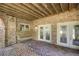 Covered brick patio featuring a swing and access to the backyard, perfect for relaxing or entertaining at 3 Woodlawn Ne Dr, Marietta, GA 30067