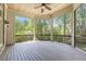 Large screened porch with wood ceiling, overlooking a private backyard with lush greenery at 3 Woodlawn Ne Dr, Marietta, GA 30067