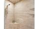 Luxurious shower with natural stone tile, a built-in seat, and upgraded fixtures at 3 Woodlawn Ne Dr, Marietta, GA 30067