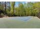The private tennis court is a great amenity for sports enthusiasts, set in a serene, tree-lined environment at 3 Woodlawn Ne Dr, Marietta, GA 30067