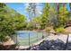A well-maintained tennis court offers recreational opportunities, surrounded by a secure fence and lush greenery at 3 Woodlawn Ne Dr, Marietta, GA 30067