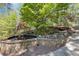 An elegant stone water feature adds a touch of tranquility to the lush backyard, complete with rockery and green foliage at 3 Woodlawn Ne Dr, Marietta, GA 30067