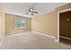 Sun-filled bedroom with a ceiling fan, large window letting in natural light, and plush neutral carpeting at 1008 Lena Nw St, Atlanta, GA 30314