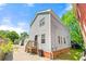 View of the home's exterior featuring light-gray siding, a small porch, and a well-maintained yard at 1008 Lena Nw St, Atlanta, GA 30314