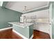 Bright kitchen features white cabinets, stainless steel appliances, and a large island with breakfast bar at 1008 Lena Nw St, Atlanta, GA 30314