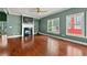 Cozy living room with fireplace, hardwood floors and large windows creating bright atmosphere at 1008 Lena Nw St, Atlanta, GA 30314