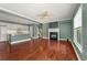 Open-concept living room with hardwood floors, fireplace, and seamless flow to the kitchen at 1008 Lena Nw St, Atlanta, GA 30314