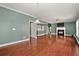 Open-concept living room with hardwood floors, fireplace, and seamless flow to the adjacent dining area at 1008 Lena Nw St, Atlanta, GA 30314