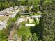Aerial view of the lot with a large, partially cleared area and fenced perimeter and several storage buildings at 3556 Finch Sw Rd, Powder Springs, GA 30127