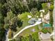 Aerial view of a home with a long driveway, situated on a partially wooded lot with a shed in the backyard at 3556 Finch Sw Rd, Powder Springs, GA 30127