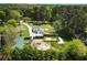 Aerial view of property with ample surrounding trees and large partially cleared lot with fenced perimeter at 3556 Finch Sw Rd, Powder Springs, GA 30127