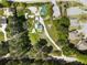 Aerial view of a property with a home, long driveway, shed, large backyard, surrounded by mature trees in a neighborhood at 3556 Finch Sw Rd, Powder Springs, GA 30127