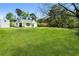 View of home featuring a large green yard with beautiful trees at 3556 Finch Sw Rd, Powder Springs, GA 30127