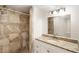 Bathroom featuring granite countertop vanity, and tiled shower with glass door at 3556 Finch Sw Rd, Powder Springs, GA 30127