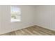 Bright bedroom featuring wood-look floors, neutral wall color, and lots of natural light at 3556 Finch Sw Rd, Powder Springs, GA 30127