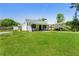 Charming home with a well-manicured lawn, gravel driveway, and mature trees at 3556 Finch Sw Rd, Powder Springs, GA 30127